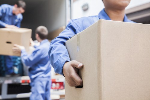 Moving team loading household items into a removal van