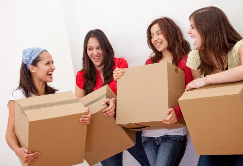 Local removals team carrying furniture through a Kingston property